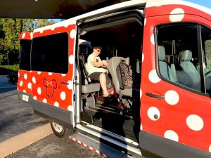 Accessible Minnie Van at Disney World with rider sitting on scooter