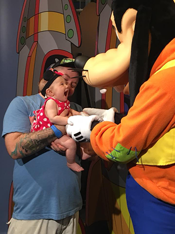 Baby enjoying Goofy at Disney World
