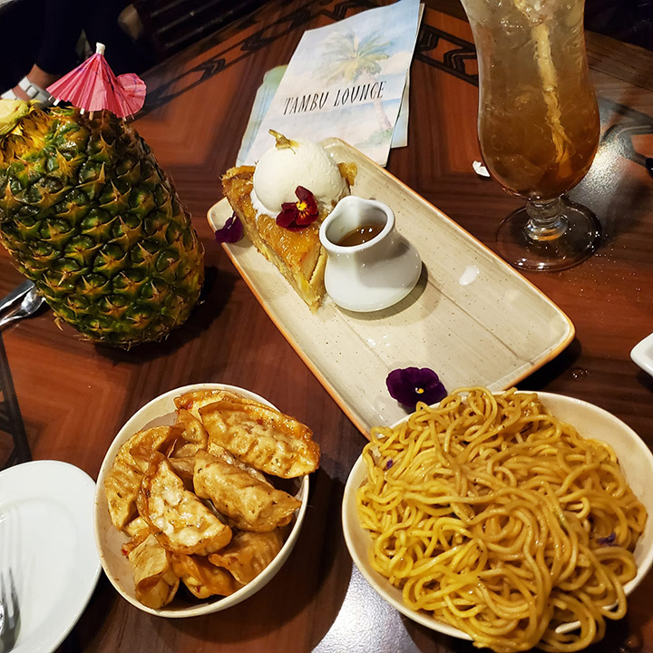 Potstickers, noodles and bread pudding served at the Tambu lounge, with a Lapu Lapu and a Long Island Iced Tea